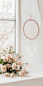 Dreamcatcher hanging in light airy room, boho decor background with copy space, AI generated