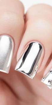 Metallic silver chrome nails closeup with rhinestone accents, vertical background, AI Generated