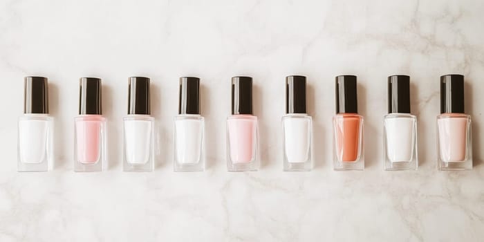 Nail polish bottles of neutral colors arranged on a marble background, AI Generated