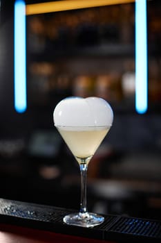 exotic alcoholic cocktail with smoky air bubble at the bar. soft drink on the bar table.