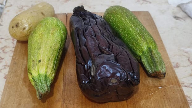 eggplants and zucchini, wooden kitchen board, food cooking. High quality photo