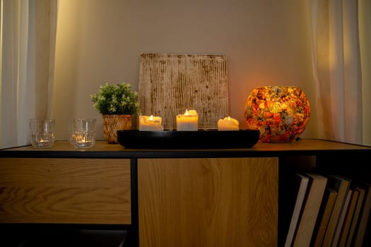 A serene setup with elegantly arranged candles, decorative plants, and warm lighting for a cozy atmosphere