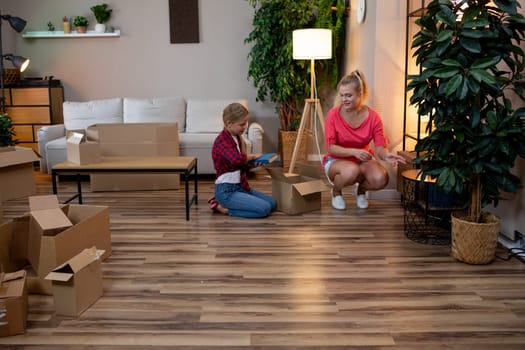 A warm and inviting scene of family bonding taking place in a cozy living room filled with unpacked boxes