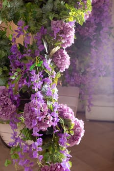 Lavish lilac and purple floral display with lush greenery in soft sunlight.