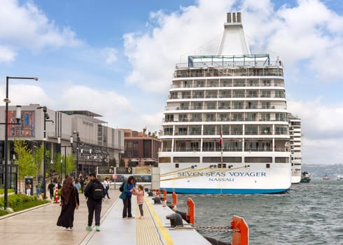 Istanbul, Turkey - May 5, 2023: SEVEN SEAS VOYAGER, Large cruise ship docked at terminal of Galataport, a mixed use development located along shore of Bosphorus strait, in Karakoy neighbourhood