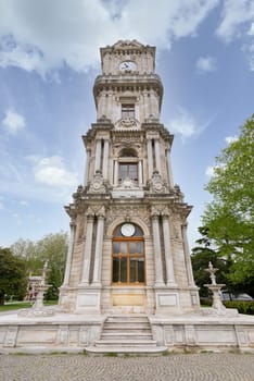 Day shot of Dolmabahce Clock Tower, Turkish: Dolmabahce Saat Kulesi, situated outside Dolmabahce Palace, Istanbul, Turkey, in a spring day