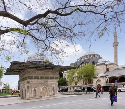 Istanbul, Turkey - May 5, 2023: Kilic Ali Pasha Fountain and Kilic Ali Pasha Mosque, built by Ottoman sultan Mahmud I, located in Tophane district of Beyoglu, beside Galataport cruise terminal
