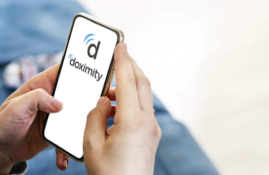 San Francisco, US, May 2023: Woman hands holding a smartphone with the Doximity logo on the screen. Healthcare focused professional networking platform. Illustrative editorial