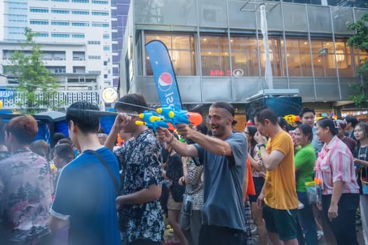Siam Square, Bangkok, Thailand - APR 14, 2023 Songkran Festival, The short action of people joins celebrations of the Thai New Year or Songkran in Siam Square Bangkok, Thailand.