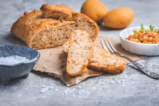 Homemade oven baked bread with carrots and onions on wooden table