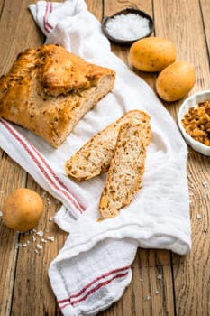 Homemade oven baked bread with carrots and onions on wooden table