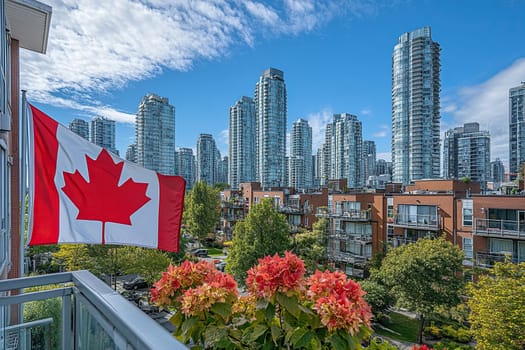 The Canadian flag flies from the balcony of a multi-story building with a city in the background.