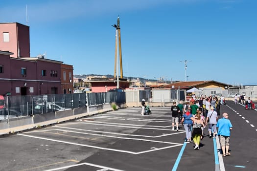 Catania, Italy, February 20, 2025: Tourists on the seafront in Catania, Sicily, enjoying a sunny day. The image captures the scenic beauty and lively atmosphere of this popular tourist destination.