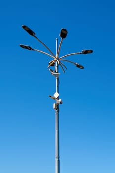 Several security cameras installed on a lamppost offering comprehensive surveillance of the urban area. The image highlights the importance of public safety and surveillance in urban environments.