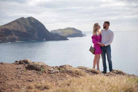 Tourists admiring the breathtaking coastal view of ponta de s o louren o, madeira island, portugal