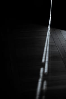 An enchanting and captivating interplay of light and shadow casting intricate and intriguing patterns on the floor