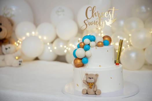 A delightful, charming layered cake that features a cute teddy bear and colorful balloons for a sweet celebration
