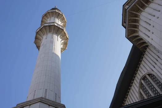 A stunning minaret rises against the clear blue sky.