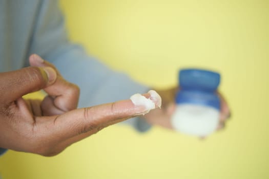 Close-up of petroleum jelly on fingers.