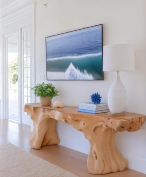 Natural wood console table with coastal decor, ocean wall art, and modern minimalist accessories in a bright interior. Interior photo concept