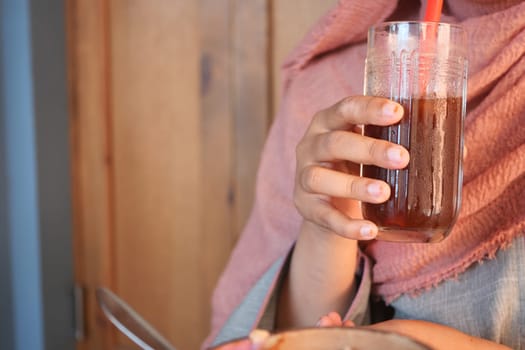 Person enjoys a refreshing drink in an inviting atmosphere.