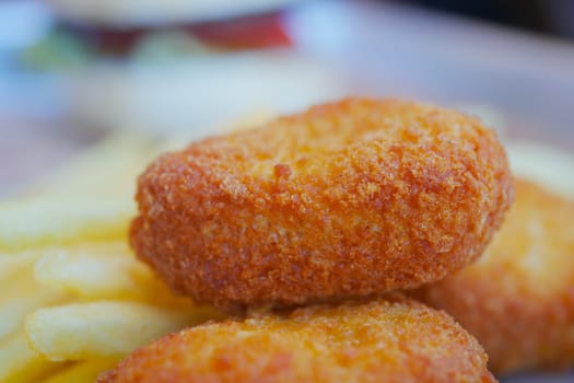 Delicious golden nuggets alongside crispy French fries in a cafe.
