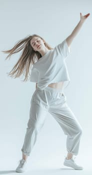 A graceful dancer effortlessly showcases captivating movement and style within a minimalist white setting