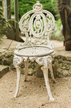 White patterned vintage antique wrought iron-shod chair