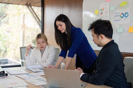 A business team is collaborating on project analysis and data presentation during a meeting, emphasizing insights and strategic planning.