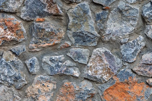Rough stones with varying colors and shapes come together, creating a striking natural aesthetic with a rustic charm.