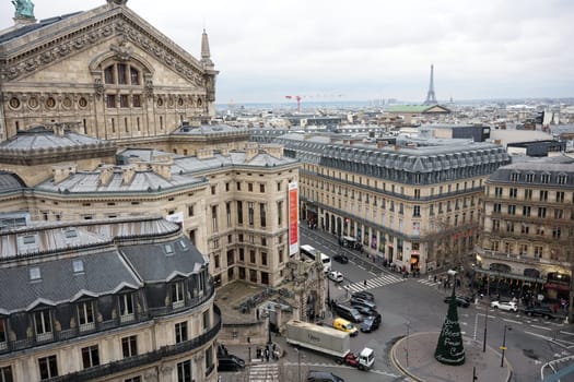Paris, France 01.24.2025. An elevated view of the Opera Garnier surrounded by elegant Parisian streets, featuring classic architecture and the Eiffel Tower.