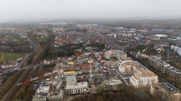 Aerial view of Amiens, France 02.20.2025, showing a mix of residential areas, ongoing construction, and railway tracks. The scene highlights urban development and expansion.