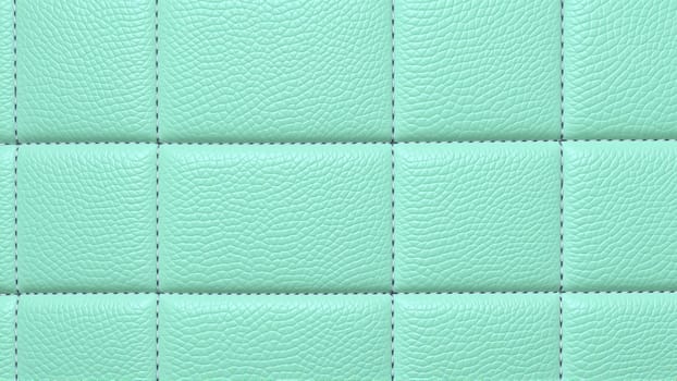 The surface texture of artificial leather in mint color, stitched in the form of rhombuses, squares, rectangles. Quilted eco-leather. High quality photo