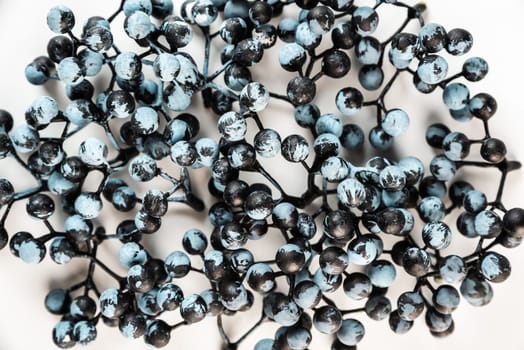 Artificial berries on a wire for needlework and decoration of gifts, wreaths on white background