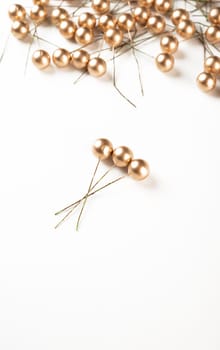 Artificial berries on a wire for needlework and decoration of gifts, wreaths on white background