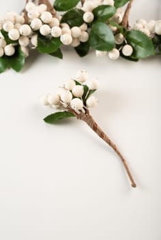 Artificial berries on a wire for needlework and decoration of gifts, wreaths on white background