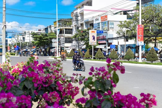 Nha Trang, Vietnam - 13 January 2023: Nha Trang city streets with traffic road and flowers for Tet Lunar New Year