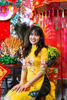 Beautiful Vietnamese woman in traditional vietnamese dress near red lanterns in Tet  Lunar New YearBeautiful Vietnamese woman in traditional vietnamese dress near red lanterns in Tet  Lunar New Year