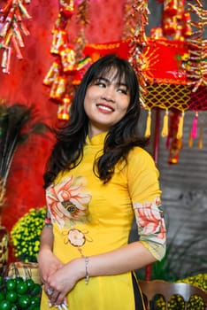 Beautiful Vietnamese woman in traditional vietnamese dress near red lanterns in Tet  Lunar New YearBeautiful Vietnamese woman in traditional vietnamese dress near red lanterns in Tet  Lunar New Year