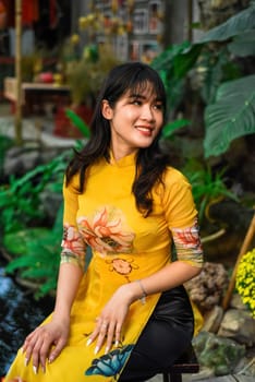 Beautiful Vietnamese woman in traditional vietnamese dress near red lanterns in Tet  Lunar New YearBeautiful Vietnamese woman in traditional vietnamese dress near red lanterns in Tet  Lunar New Year