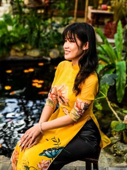 Beautiful Vietnamese woman in traditional vietnamese dress near red lanterns in Tet  Lunar New YearBeautiful Vietnamese woman in traditional vietnamese dress near red lanterns in Tet  Lunar New Year