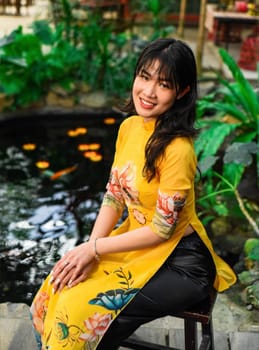 Beautiful Vietnamese woman in traditional vietnamese dress near red lanterns in Tet  Lunar New YearBeautiful Vietnamese woman in traditional vietnamese dress near red lanterns in Tet  Lunar New Year