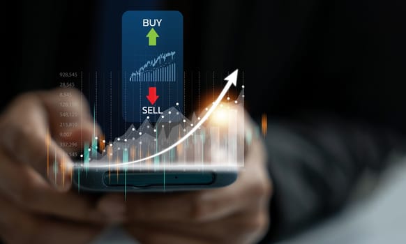 Successful businessman checking stock market trends and currency exchange rates on his mobile phone app. Finance and investment concept.