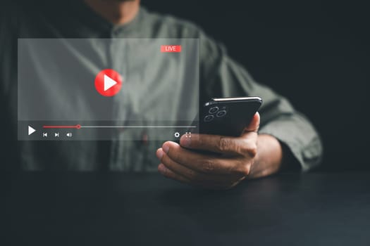Witness the magic of online movie streaming on a smartphone as a young man explores the virtual world of film. Embrace the seamless integration of technology, entertainment, and imagination.