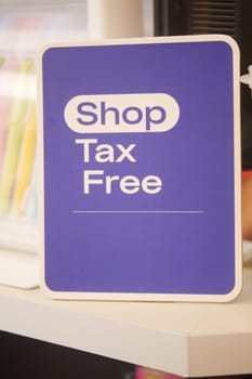 Sign indicating tax-free shopping available in a retail store setting