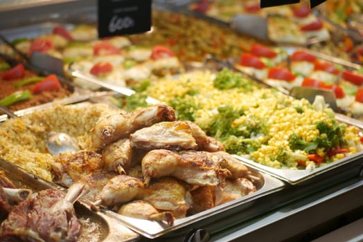 Plates filled with assorted dishes including chicken and vegetables.