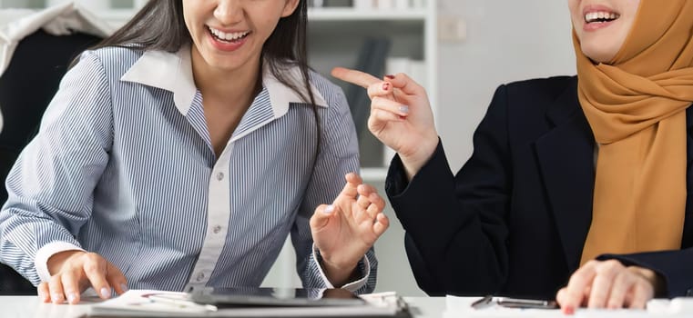 Two engaged financial professionals share ideas and strategies, highlighting collaboration and diversity in a vibrant office space.