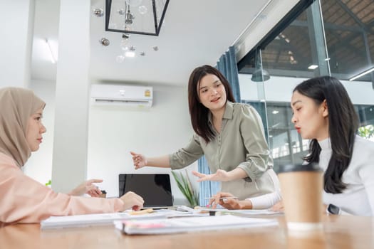 A diverse team of financial professionals collaborates on strategies and reports in a contemporary office environment.