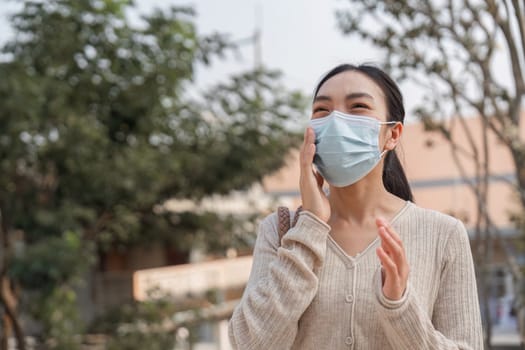A young woman smiles while wearing a mask, addressing the importance of pollution awareness and health safety.