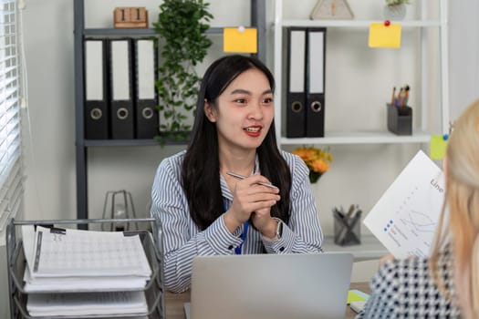 A diverse team collaborates on tax planning and analysis, showcasing teamwork and professional engagement in a modern office.